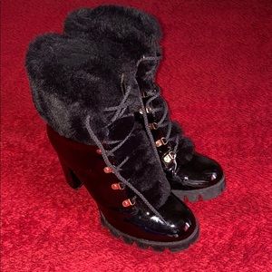 A black, lace up heel boot.